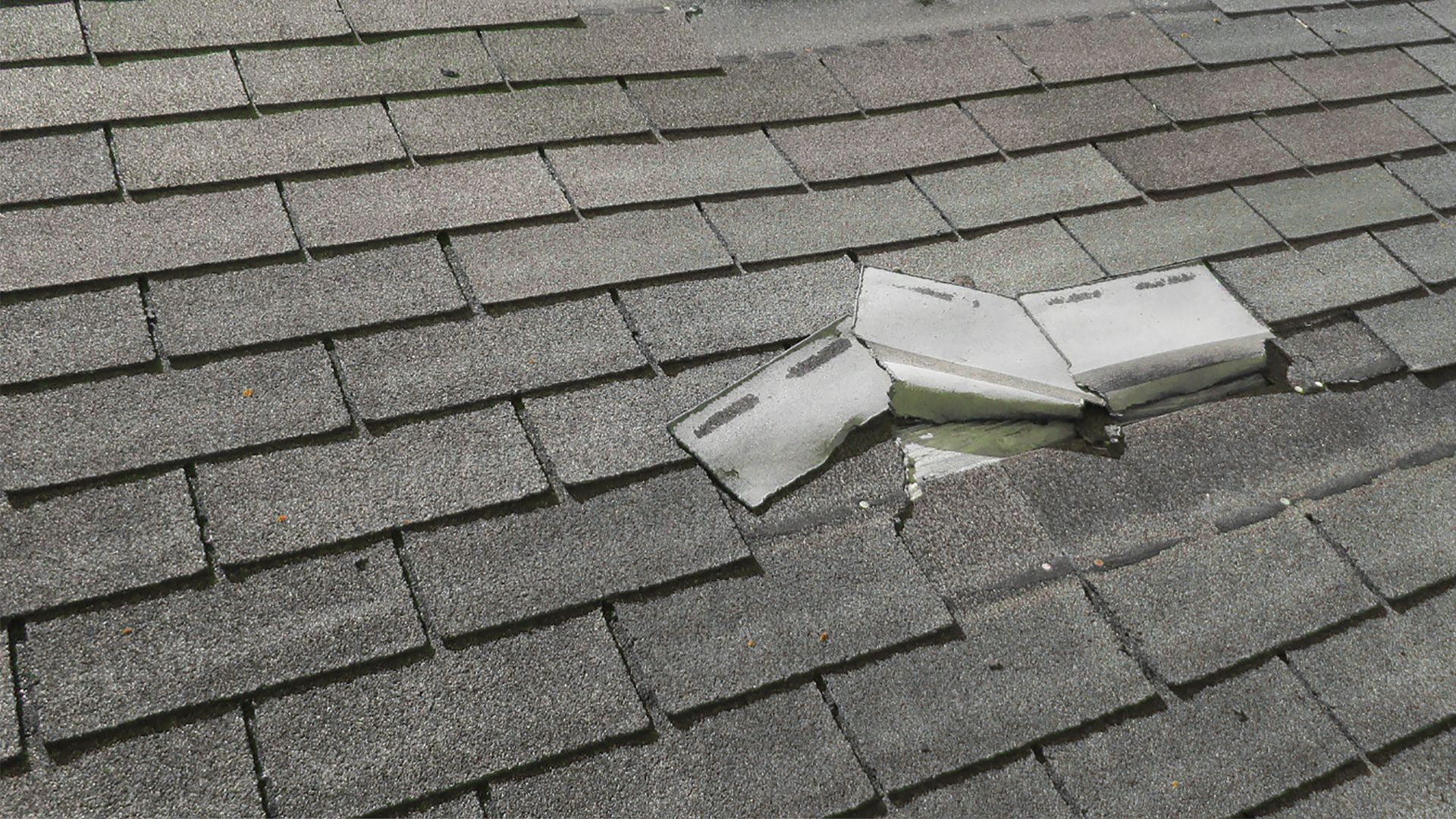 A roof that has a broken piece of paper on it